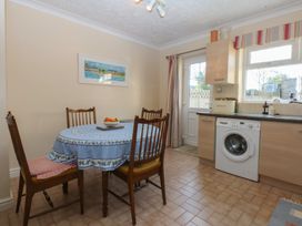 A kitchen with a table and chairs at 15 Rose Hill Beaumaris