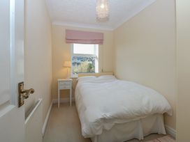 A bedroom with a bed and side table at 15 Rose Hill Beaumaris
