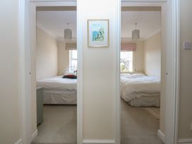 A view of two bedrooms with beds and a picture frame at 15 Rose Hill Beaumaris