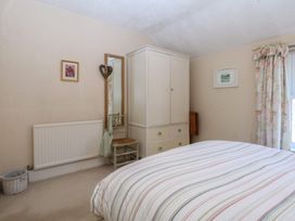 A bedroom with a bed and wardrobe at 15 Rose Hill Beaumaris