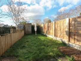 A garden with a tree and wooden fence at 15 Rose Hill Beaumaris
