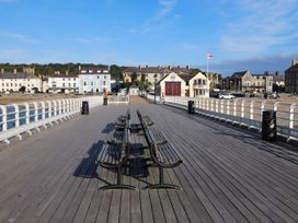 A pier with benches and a building at 15 Rose Hill Beaumaris