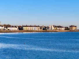 A view of buildings along the shore by water at 15 Rose Hill Beaumaris