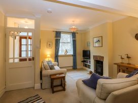 A living room with a sofa and television at 15 Rose Hill in Beaumaris