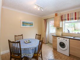 A kitchen with a table and chairs at 15 Rose Hill in Beaumaris