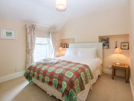 A bedroom with a bed and lamp at 15 Rose Hill Beaumaris