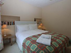 A bedroom with a bed and nightstand at 15 Rose Hill Beaumaris