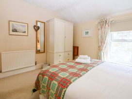 A bedroom with a bed and wardrobe at 15 Rose Hill Beaumaris