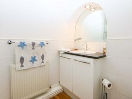 A bathroom with a sink and mirror at 15 Rose Hill Beaumaris