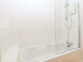 A bathroom with a bathtub and shower at 15 Rose Hill Beaumaris