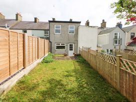 A backyard with a house and fence at 15 Rose Hill Beaumaris
