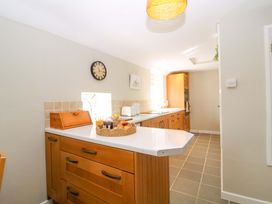 A kitchen with cabinets and a counter at Farm View Annex in Painswick