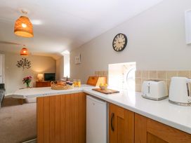 A kitchen with a refrigerator and toaster at Farm View Annex in Painswick