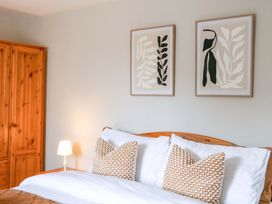 A bedroom with a bed and wardrobe at Farm View Annex in Painswick