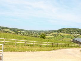 A view of hills and fields with a fence and shed at Farm View Annex in Painswick