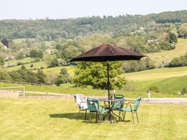 An outdoor area with a table and chairs at Farm View Annex in Painswick