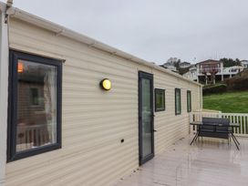 An exterior view of a property with windows and a door at Gorse Hill 211 Exmouth
