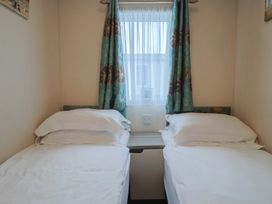 A bedroom with two beds and a window at Gorse Hill 211 in Exmouth