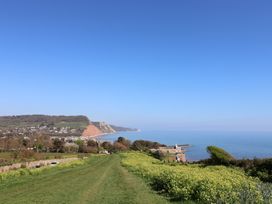 A coastline view with grass and cliffs at Gorse Hill 211 in Exmouth