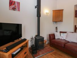 A living room with a television and stove at The Spinney near Milnthorpe
