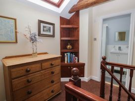 A hallway with a dresser and bookshelf at The Spinney near Milnthorpe