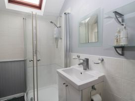 A bathroom with a shower and sink at The Spinney near Milnthorpe