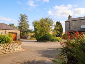 An outdoor view with a house and garage at The Spinney near Milnthorpe