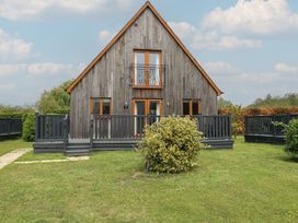 A house with a deck and balcony at James Ville Marina Lodge 8 in Brigg