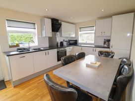 A kitchen with a table and chairs at James Ville Marina Lodge 8 in Brigg