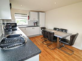 A kitchen with a dining table and chairs at James Ville Marina Lodge 8 in Brigg