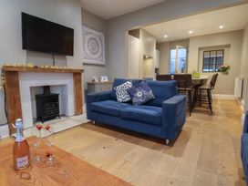 A living room with a sofa and fireplace at South Villa Sandsend near Whitby