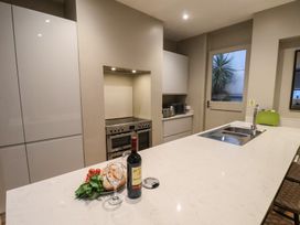 A kitchen with an island and wine bottle at South Villa in Sandsend near Whitby