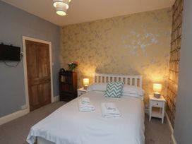 A bedroom with a bed and nightstand at South Villa Sandsend near Whitby