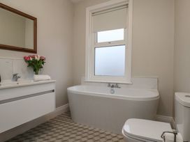 A bathroom with a bathtub, sink, and toilet at South Villa in Sandsend near Whitby