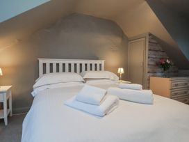 A bedroom with a bed and bedside table at South Villa in Sandsend near Whitby