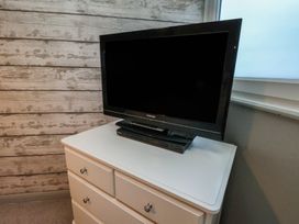 A television and DVD player on a chest of drawers at South Villa in Sandsend near Whitby