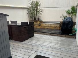 An outdoor area with a table and chairs at South Villa Sandsend near Whitby