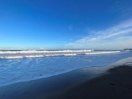 A beach view with waves and blue sky at South Villa Sandsend near Whitby