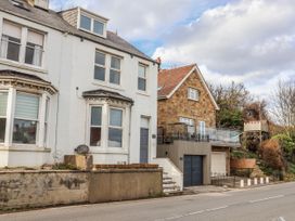 A street view with two houses and a garage at South Villa in Sandsend near Whitby
