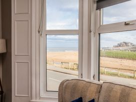 A living room with a beach view at South Villa Sandsend near Whitby