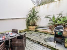 An outdoor area with a dining set and barbecue at South Villa Sandsend near Whitby