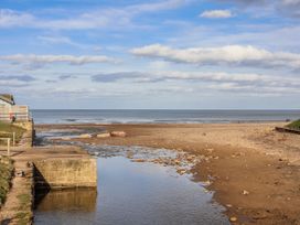 A beach scene with water and sand at South Villa in Sandsend near Whitby