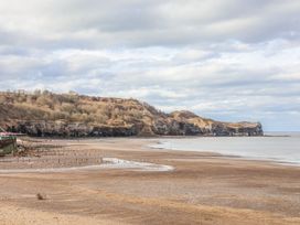 A beach with cliffs and sea at South Villa in Sandsend near Whitby