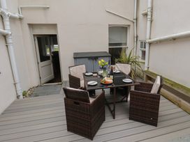 An outdoor dining area with a table and chairs at South Villa in Sandsend near Whitby