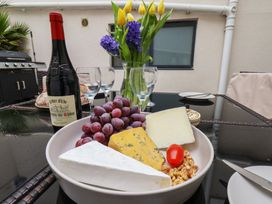 A cheese platter with grapes and wine at South Villa in Sandsend near Whitby