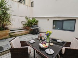 An outdoor patio area with a table and chairs at South Villa in Sandsend near Whitby