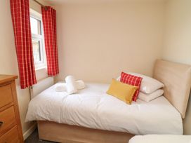 A bedroom with a bed and furniture at James Ville Marina Lodge 9 in Brigg