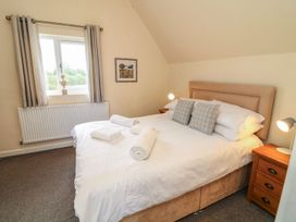 A bedroom with a double bed and window at James Ville Marina Lodge 9 in Brigg
