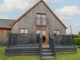A wooden house with a balcony and steps at James Ville Marina Lodge 9 in Brigg