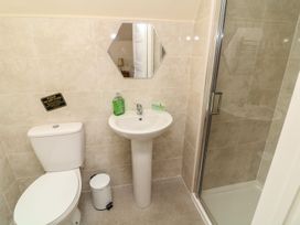 A bathroom with a sink, toilet, and shower at James Ville Marina Lodge 13 in Brigg